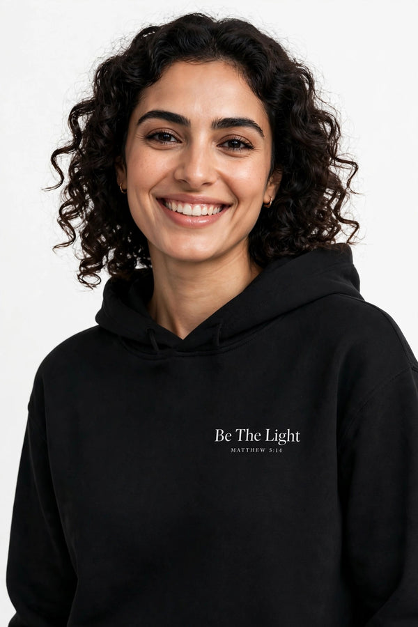 Woman wearing the Be The Light hoodie in black