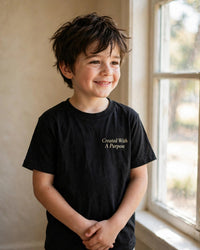 Thumbnail for Kids Created With A Purpose Tee - worn front by the window, Black