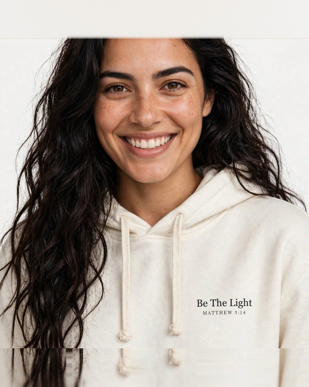 Woman wearing the Be The Light hoodie in cream