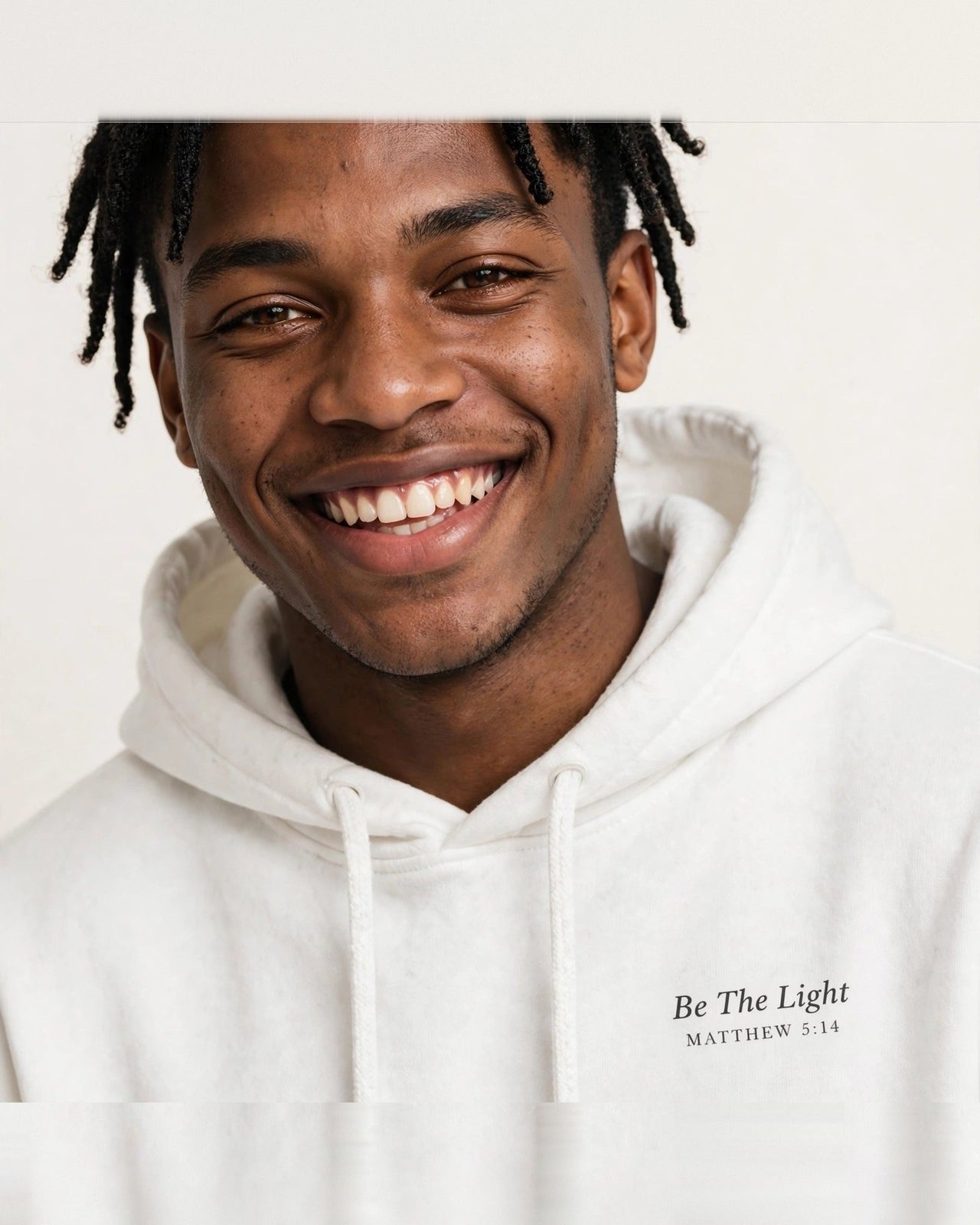 Man wearing the Be The Light hoodie in white