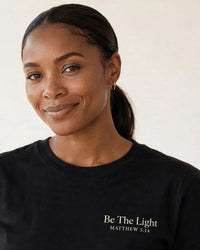Thumbnail for Be The Light tee in black, small left-chest print