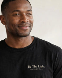 Thumbnail for Man wearing the Be The Light tee in black