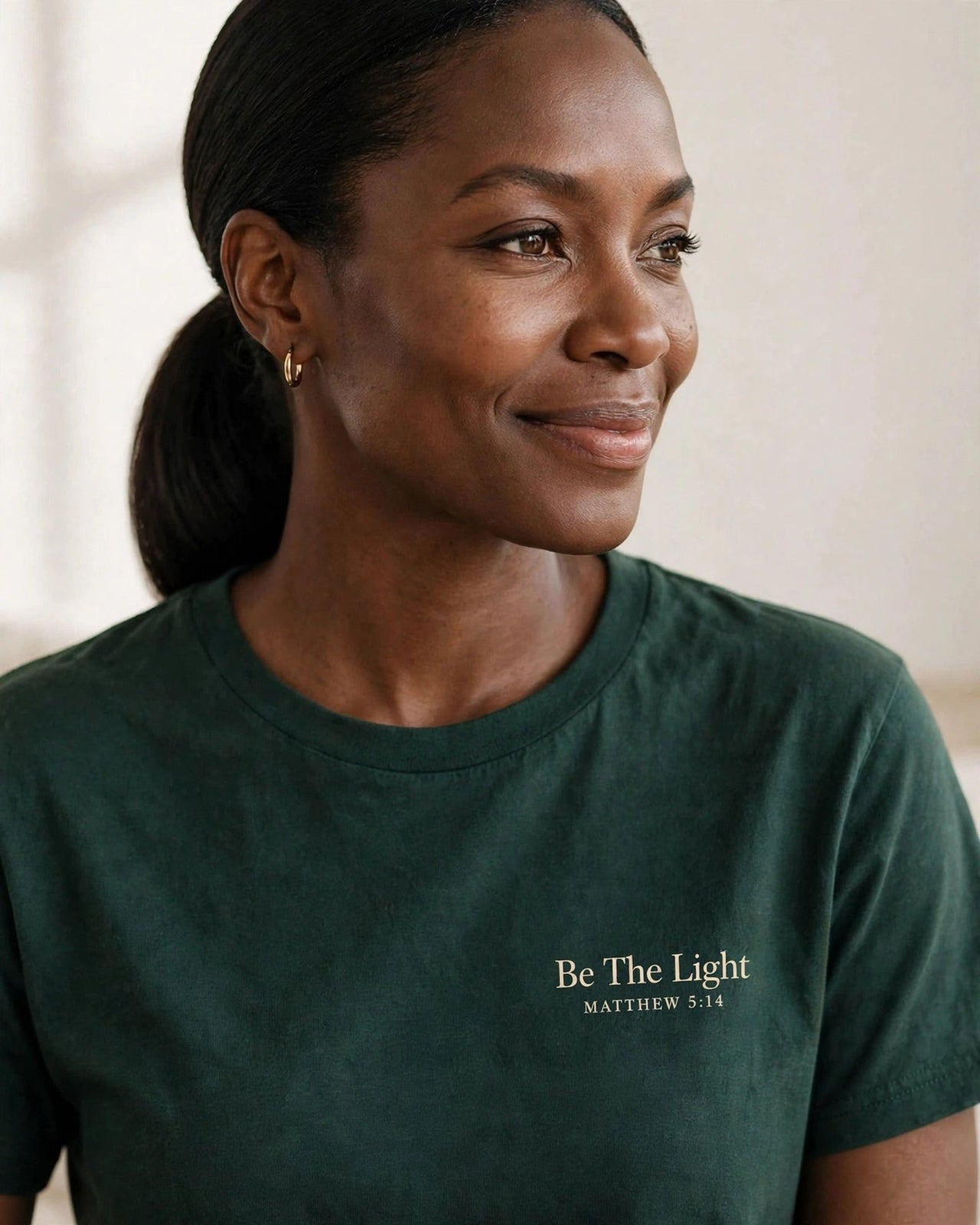 Be The Light tee in dark green, small left-chest print