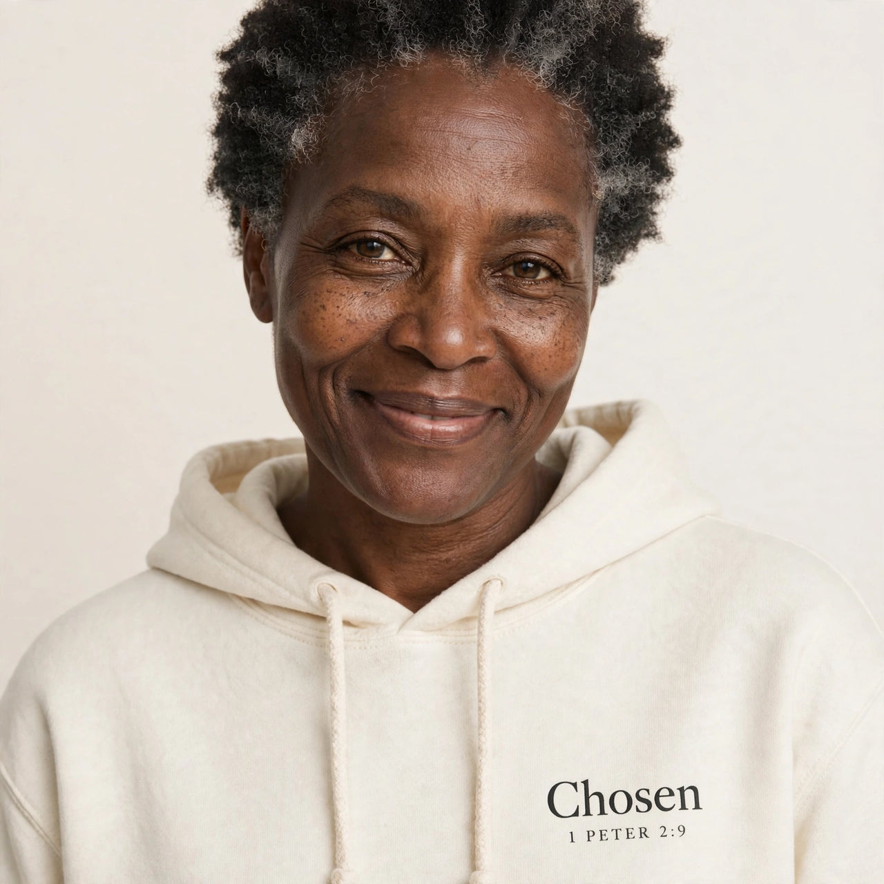 Woman wearing the Chosen hoodie in cream