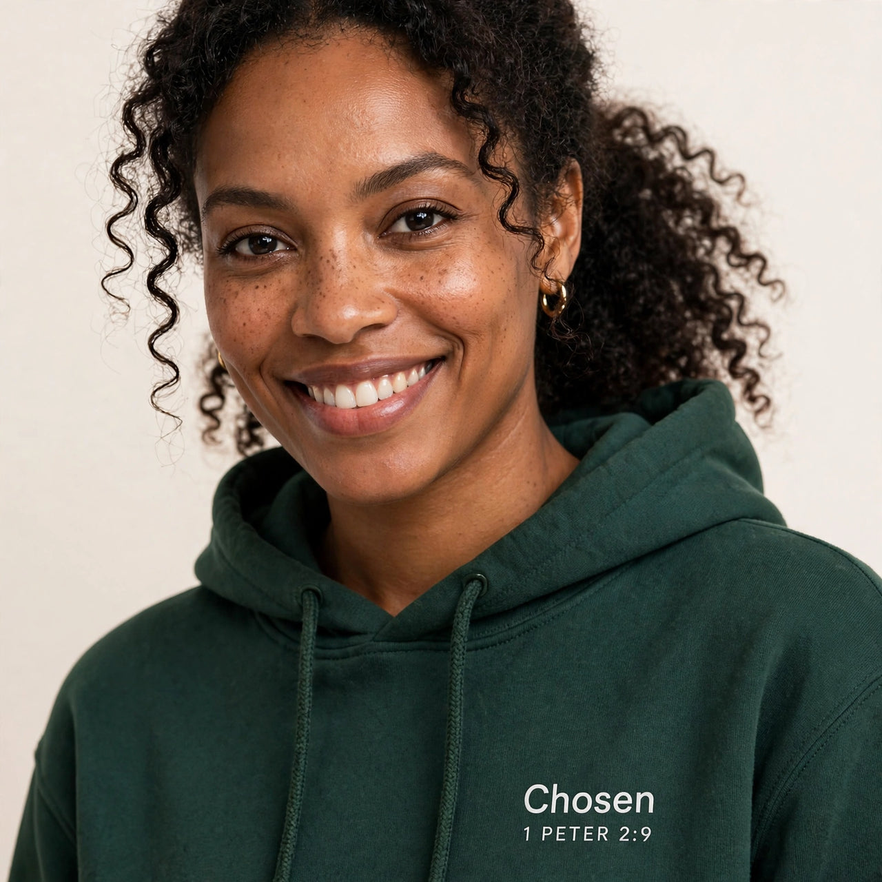 Woman wearing the Chosen hoodie in dark green