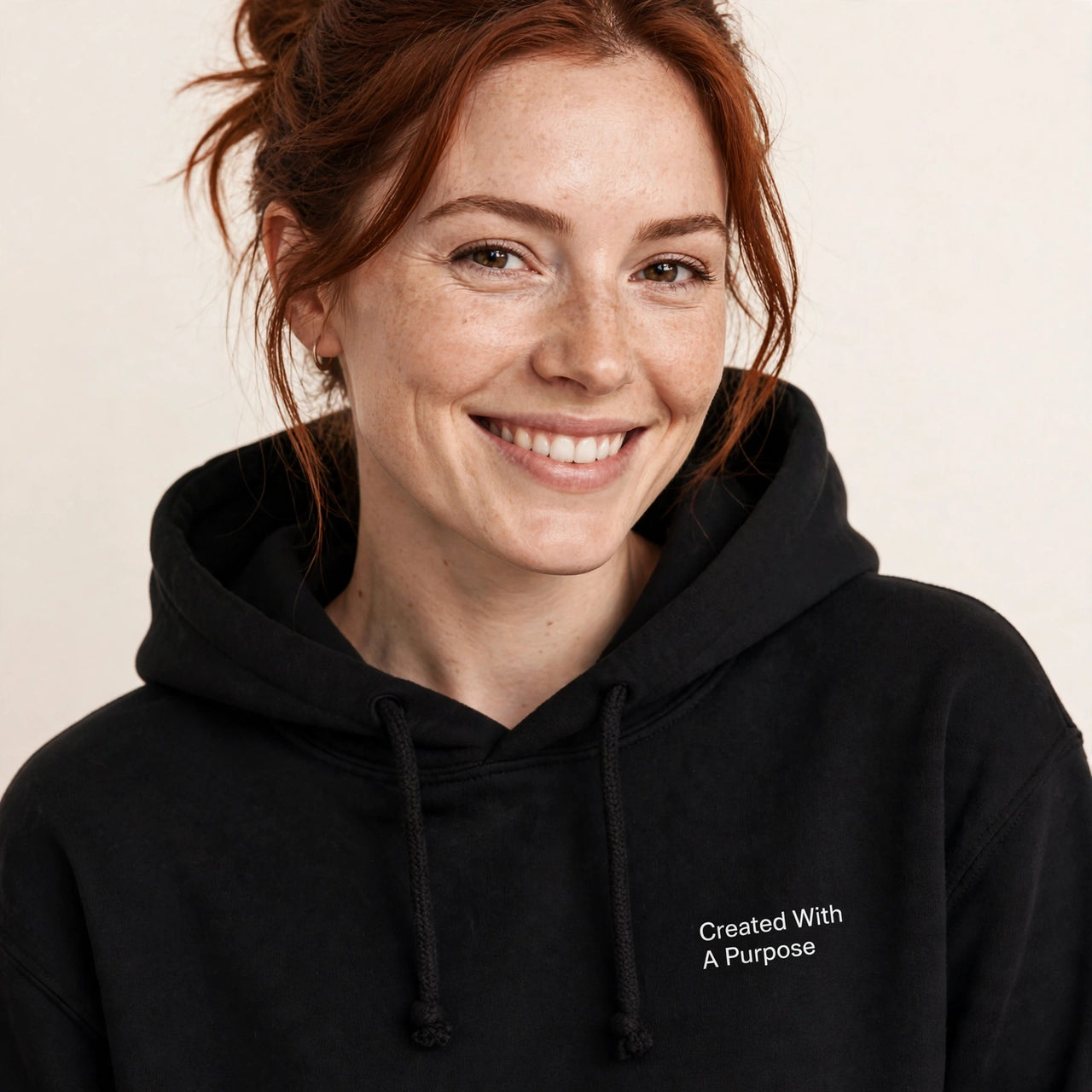 Woman wearing the Created With A Purpose hoodie in black