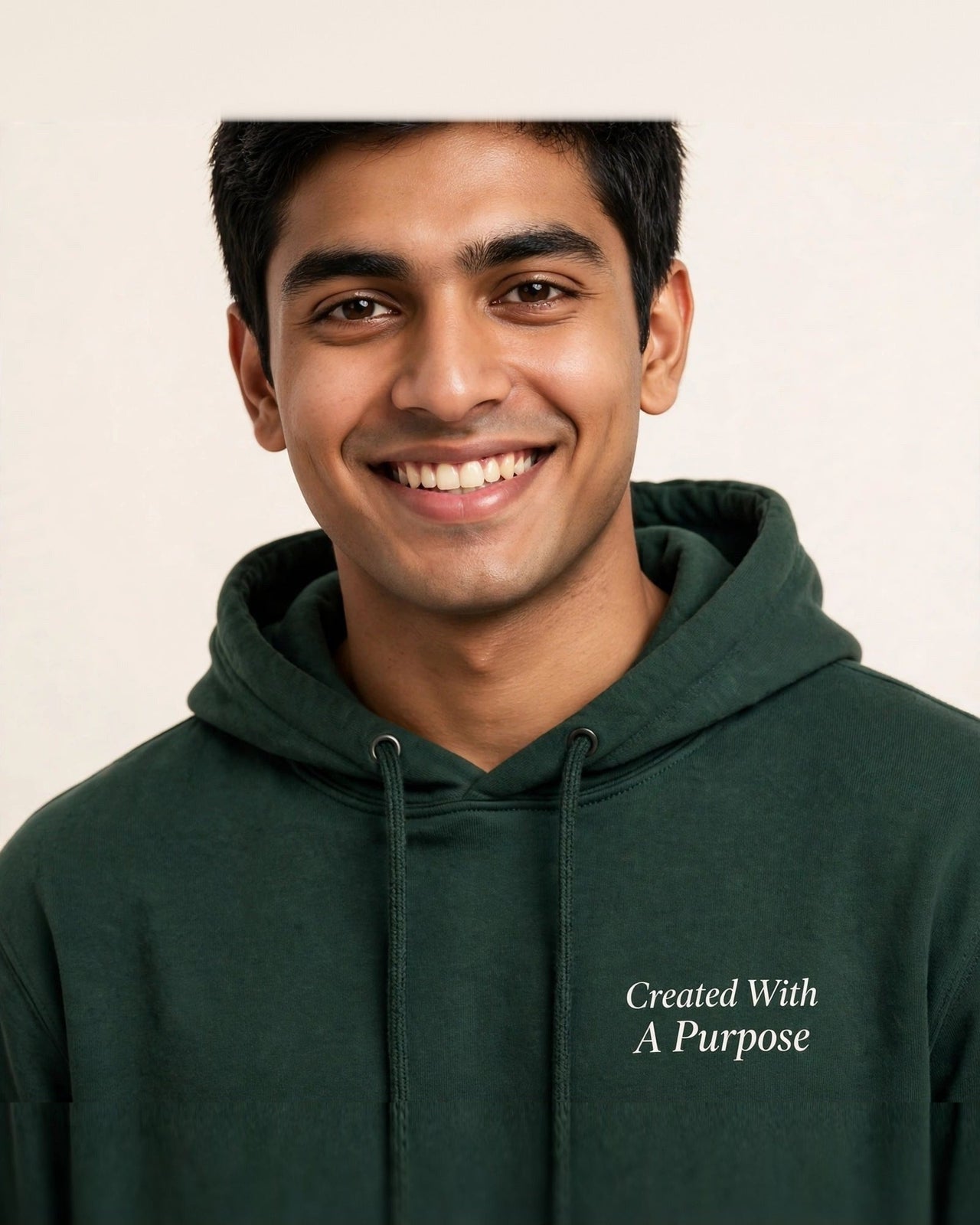 Man wearing the Created With A Purpose hoodie in dark green