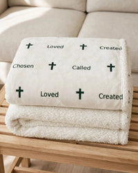 Thumbnail for Folded stack of sherpa fleece blankets showing the sherpa edge and layers