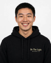 Thumbnail for Man wearing the Be The Light hoodie in black