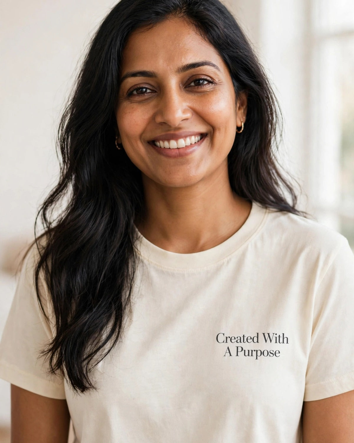 Woman wearing the Created With A Purpose tee in cream
