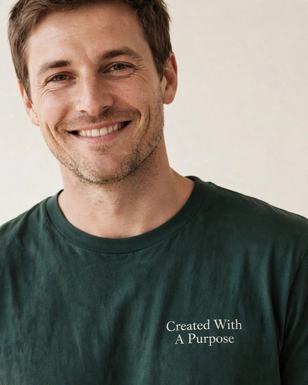 Man wearing the Created With A Purpose tee in dark green