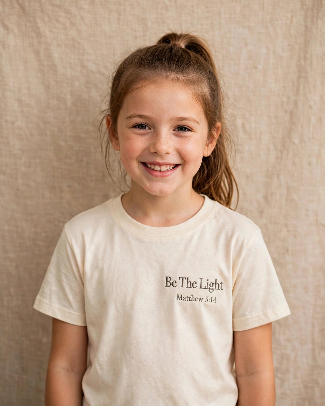 Kids tee mockup — Be The Light, Cream